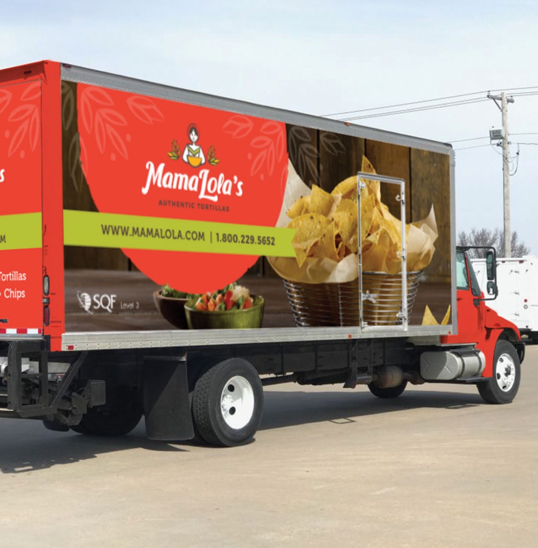 A Mama Lola's delivery truck featuring tortilla chips and salsa graphics on its side